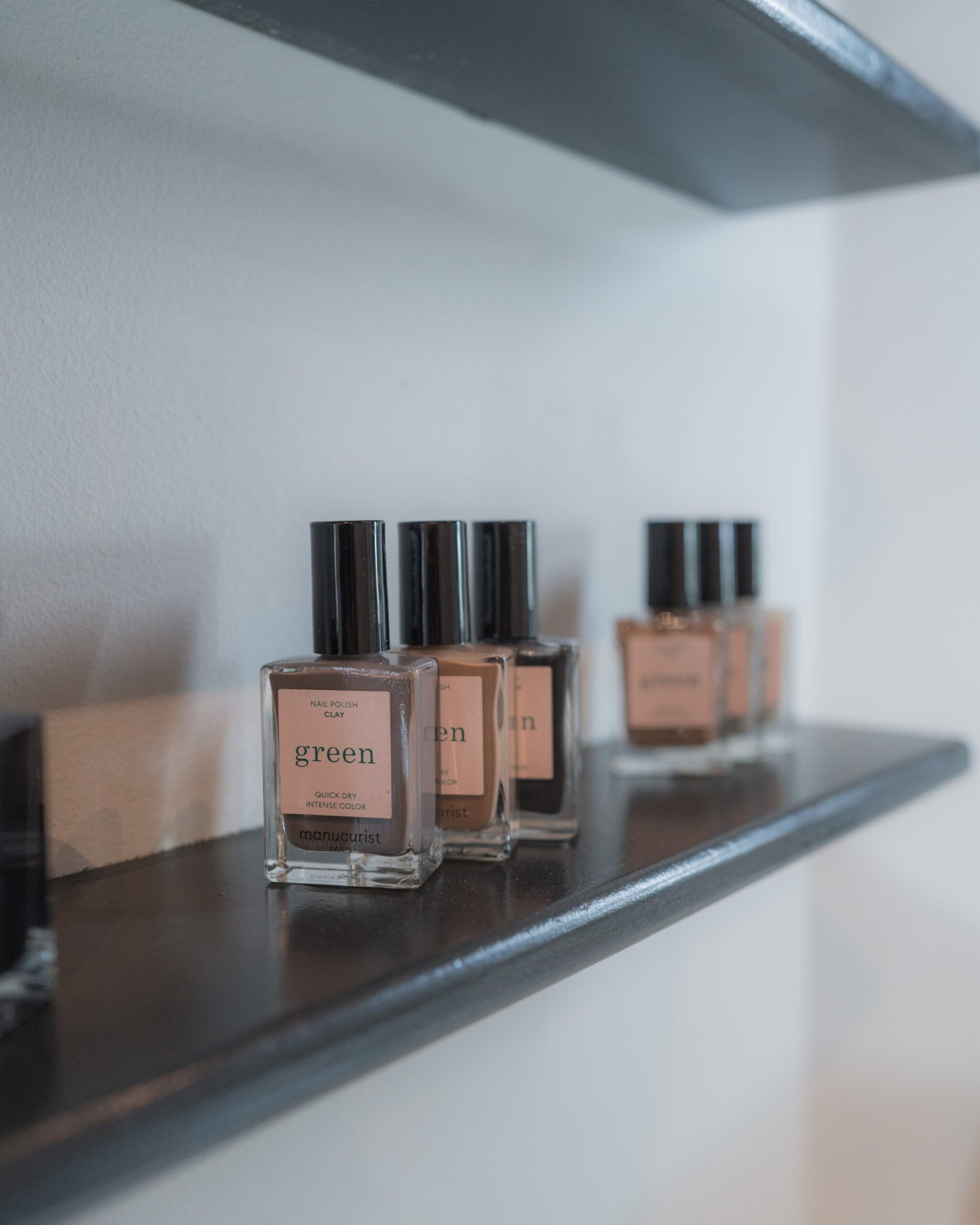 Nail polish shades on a studio shelf